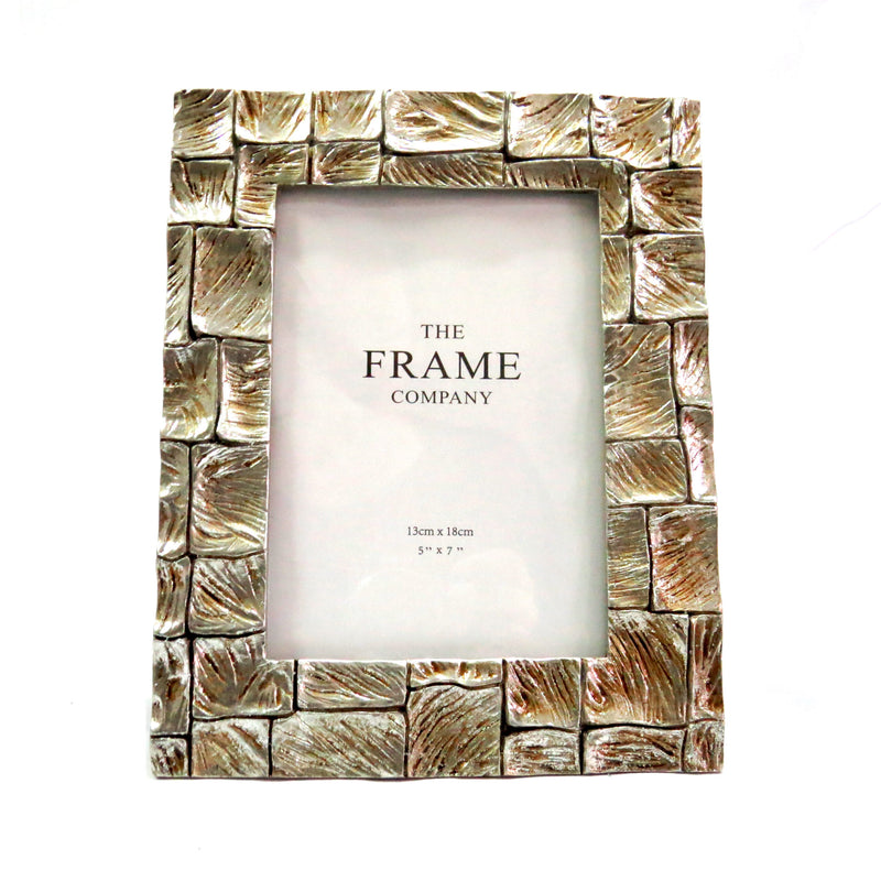 Experience the beauty and elegance of the Barkhuizen Frame. Its sleek design boasts a 5" x 7" frame, perfect for showcasing your favorite memories. Made with high-quality materials, this frame is sure to add a touch of sophistication to any room. Elevate your decor and display your photos with style-unique interiors