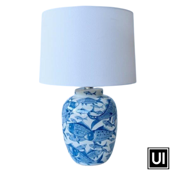 Blue & white fish lamp base off white shade 605x46cm  Introducing our Blue & White Fish Lamp Base from Unique Interiors, a stunning piece that will add a touch of whimsy to any room in your home. This lamp base is expertly handcrafted to perfection, ensuring the highest quality of craftsmanship.