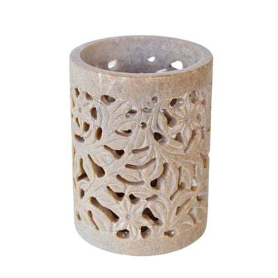This beige soap stone cutout tumbler offers a unique look and feel. It's crafted from durable soapstone and designed with detailed, hand-carved cutouts. Its unique texture and lightweight build provide a comfortable grip for easy drinking.