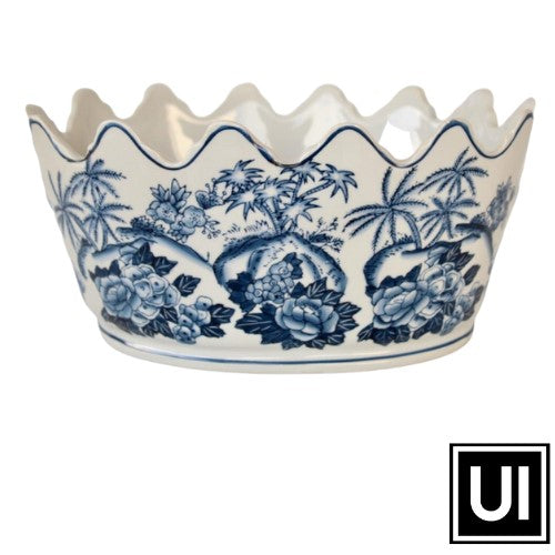 This Blue scalloped planter adds a touch of elegance to any outdoor or indoor living space. Crafted from a glossy glazed ceramic material, this 13x27x21cm planter is ideal for displaying small plants, flowers or succulents with style. Its scalloped detailing and deep color exudes sophistication and elevates any room.  Unique Interiors