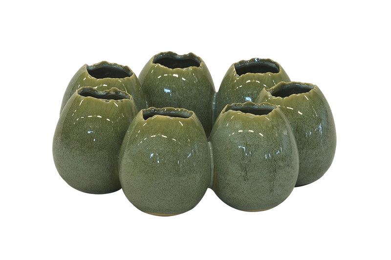 Crafted from high-quality ceramic, this Ostrich Egg Ring Vase in green is a stunning addition to any home decor. Measuring 25CM in diameter and 10CM in height, it is perfect for displaying your favorite flowers or as a standalone piece. Elevate your interior design with this unique and elegant vase-UNIQUE INTERIORS