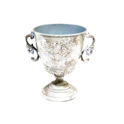 Introducing the Far Pavilion Trophy, a stunning 21cm wide pot made of antique silver metal with a 16cm diameter opening and a height of 21cm. Use it as a vase or urn, this versatile and elegant piece adds beauty to any space. Expertly crafted for both aesthetics and functionality.UNIQUE INTERIORS.
