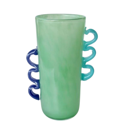 TALL GREEN GLASS VASE PURPLE, BLUE HANDLES 30X19X14CM Add a touch of elegance to your home decor with this white frosted glass vase. Featuring delicate pink and aqua blue handles, this vase is a beautiful addition to any room. Its versatile size of 20x20x12.5cm makes it perfect for displaying flowers or as a standalone piece.  DELIVERY 5 to 7 working