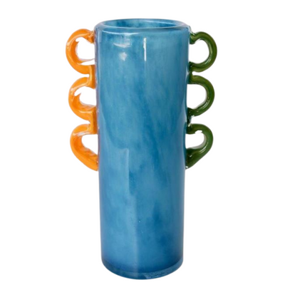 TALL BLUE GLASS VASE ORANGE, GREEN HANDLES 27.5X15X10CM Expertly crafted, the TALL BLUE GLASS VASE features vibrant orange and green handles, adding a unique touch to your home decor. Measuring 27.5x15x10cm, this hand-blown vase is perfect for displaying your favorite flowers or as a standalone statement piece. Elevate your interior design with this stunning addition.  DELIVERY 5 to 7 working