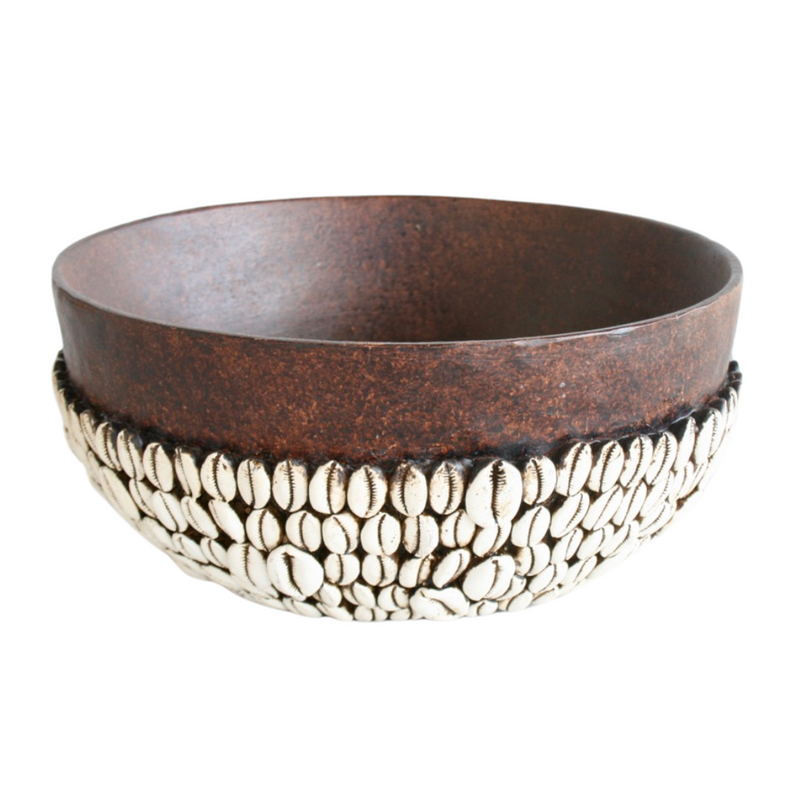 AFRICAN BOWL WITH CORIE SHELLS DESIGN 14X30CM Expertly handmade in Africa, this beautiful bowl features an intricate design of corie shells. Measuring 14x30cm, it adds a touch of African culture to any home. Support local artisans and elevate your decor with this unique piece.   Delivery fee 5 to 7 working days