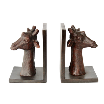 PAIR OF GIRAFFE HEAD BOOK ENDS 20X70X12CM These Giraffe Head Bookends are both functional and stylish, providing a unique way to organize your books while adding a touch of nature to your home. Made of sturdy resin, each bookend measures 20x70x12cm and features an elegant giraffe head design. Perfect for animal lovers and book enthusiasts alike.  Delivery fee 5 to 7 working days