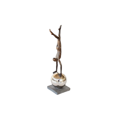 Enjoy the unique and eye-catching design of our Man on Silver Ball. Standing at 51x13x13cm, this sculpture features a polished silver finish that adds a touch of elegance to any room or office. Made with high-quality materials, it is a durable and timeless piece that will surely impress.UNIQUE INTERIORS