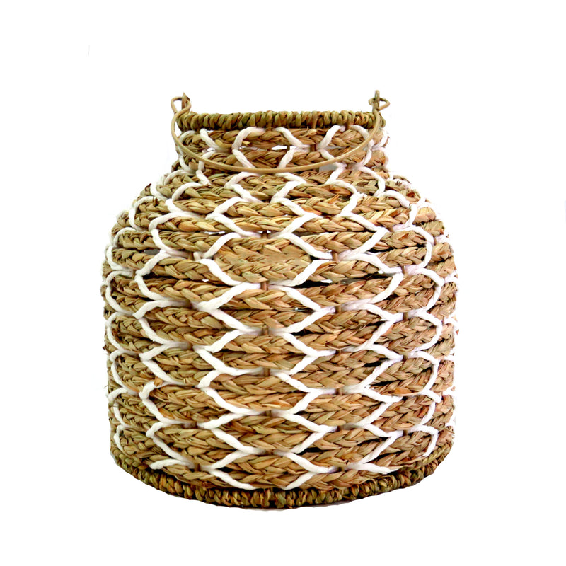 The Sunset Strip Lantern is expertly crafted with handwoven natural material rope, encircling a sturdy metal frame. The soft white accents in the weaving add a touch of elegance to this highly desirable lantern, measuring 14.5cm in top diameter and 26cm in both height and base. With a circumference of 82cm, it includes a metal frame and a glass insert (10cm x 10cm) inside-unique interiors
