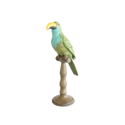 Toucan on stand green and turquoise 42X16cm  Bring life to your home décor with this vibrant toucan on stand! The bright green and turquoise colors are sure to bring a touch of beauty to any room. At 42X16cm, this exotic bird is sure to be an eye-catching centerpiece. Who can resist its captivating charm?    Delivery 5 - 7 working days