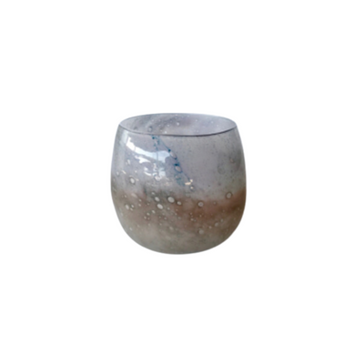 Beige shimmery glass candle holder 20X17cm  This beige glass candle holder boasts a shimmery finish and measures 20x17cm, perfect for adding a soft touch and a hint of warmth to any setting. The timeless design of the glass holder is ideal for dinner parties or special occasions, adding a touch of sophistication to any event.     Delivery 5 - 7 working days