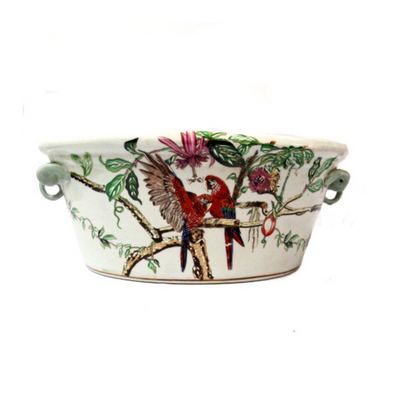 This vintage Zanzibari foot bath is a perfect decor piece for your home. Crafted from porcelain and hand painted with colorful parrots and flowers, it's sure to add an elegant touch to any space. Measuring 43cmL x 30cmW x 19cmH, this classic foot bath makes an impressive statement. UNIQUE INTERIORS.
