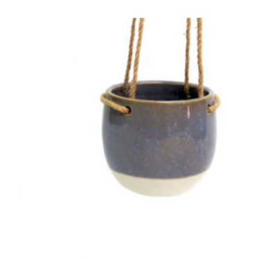 Elevate your plant game with the In Clover Hanging Pot. The 13.2CMD x 11.5CMH two-toned pot features a smoky blue glaze on an off-white base, suspended by jute hangers (which can also be easily removed). Perfect for adding a touch of sophistication to any space.UNIQUE INTERIORS.