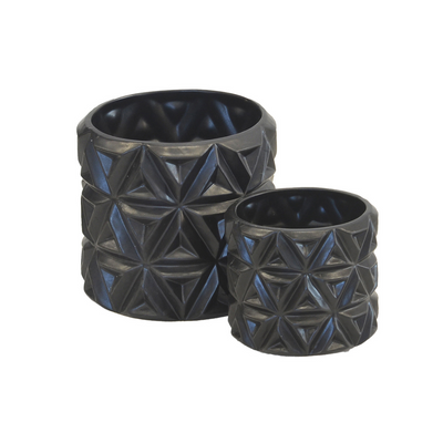 This set of two ceramic planters features a carved flower design with a matte black finish. The larger one measures 16cm in height and 16cm in diameter, while the smaller one is 12cm in height and 12cm in diameter. Both are crafted of ceramic porcelain for long-lasting use and are sure to add a unique decorative touch to any interior.  Ceramic carved flower matt black s/2  Size  16CM (H) X 16CM (D)  12CM (H) X 12CM (D)  Ceramic porcelain decor planter pot.  Unique Interiors