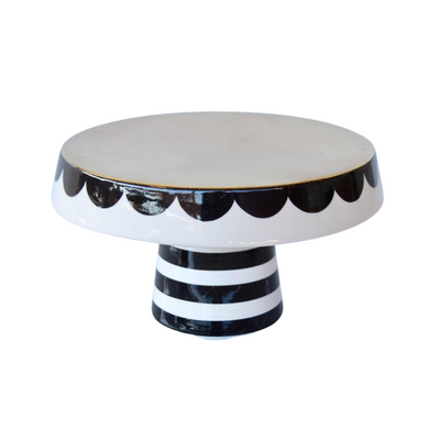 Impress your guests with this stylish black and white cake stand. Crafted with a scalloped edge and measuring 26.5x28cm, its classic design ensures a sophisticated look for your next event. Enjoy hosting in style with this unique and beautiful piece.  Delivery 5 - 7 working days