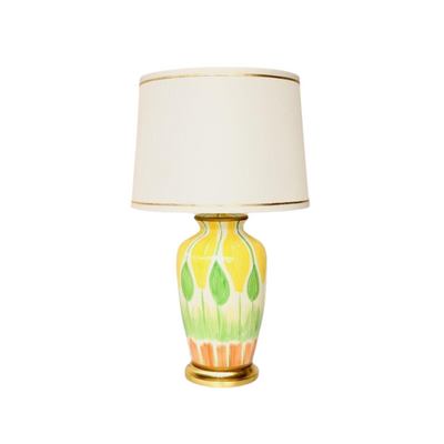 This Hand-Painted Table Lamp boasts a vibrant, eye-catching colour palette of yellow, green, and orange, complete with a Gold Trim Shade. This captivating lighting solution measures 68x40cm.  Delivery 5 - 7 working days