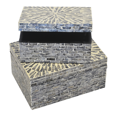 This Mop Box Capiz Grey Brick S/2 is sure to add an instant touch of style to any home. Its unique design stands out with two differently sized boxes - 30cm x 22cm x 15cm and 25cm x 17cm x 12cm - making it a must-have addition to your decor. Its design makes it ideal for storing and displaying any accessories.  Mop box capiz grey brick s/2