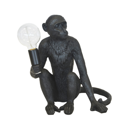 Add a unique touch to your home with this 40 cm (H) resin monkey table lamp. Crafted from high-quality resin, this unique interior decor piece features a striking black finish and ornamental lighting. Globe not included.  Resin monkey lamp x.large black  40CM (H)  A striking black monkey table lamp for the perfect addition to your home.  Globe not included  Interior Decor Piece.  Ornamental lighting.  Unique Interiors 