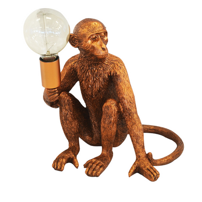 This stylish copper monkey table lamp adds the perfect touch to any home. At 40cm (H), its ornamental design offers a unique piece of interior decor. Its bold colour adds a vivid pop to your interior, making it a visually impactful conversation piece.  Resin monkey lamp x.large copper  Size  40CM (H)  A striking rich copper monkey table lamp for the perfect addition to your home.  Interior Decor Piece.  Ornamental lighting.  Unique Interiors 