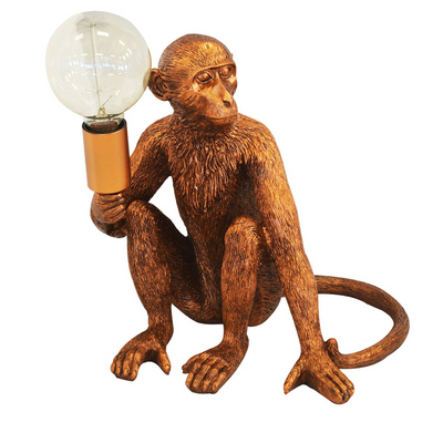 Bring a unique charm to your home with this 30cm copper monkey torch table lamp. Crafted from premium resin, this eye-catching piece is sure to become a conversation starter and a centerpiece of your interior decor. With a timeless design, the piece offers a stunning addition to any room.  Resin monkey torch copper  Size  30CM (H)  Monkeys are back in town!!! Rich copper monkey table lamp for the perfect addition to your home.  Interior Decor Piece.  Unique Interiors 
