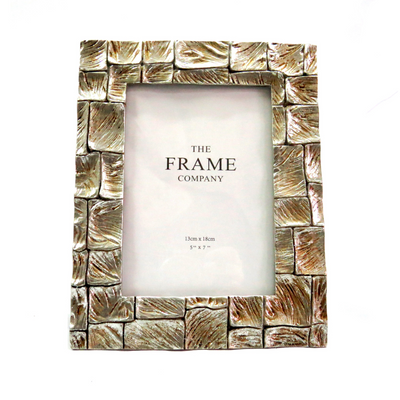 Experience the beauty and elegance of the Barkhuizen Frame. Its sleek design boasts a 5" x 7" frame, perfect for showcasing your favorite memories. Made with high-quality materials, this frame is sure to add a touch of sophistication to any room. Elevate your decor and display your photos with style-unique interiors