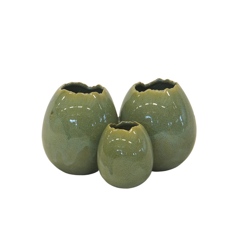Introduce your space to a touch of exotic luxury with our Ceramic Ostrich Egg Ring Vase in Green. This small-sized vase boasts dimensions of 16CM x 10CM x 10CM (H), making it the perfect accent piece for any tabletop or shelf. Its unique design adds a sophisticated touch to any room, creating a statement piece that is both functional and stylish. Elevate your home decor with this eye-catching vase today-UNIQUE INTERIORS