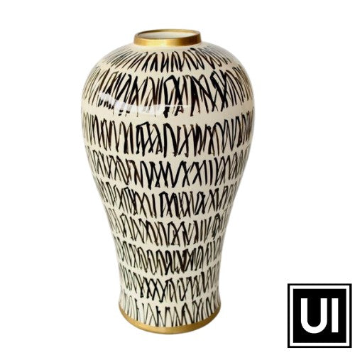 This White with black design vase will add a touch of sophistication to any room in your home. It is made of ceramic and measures 43x23 cm for optimal decoration. Its sleek design will enhance the aesthetic of any home.  Unique Interiors Lifestyle 