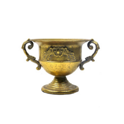 This stunning Vetiver Vase features an exquisite design, complete with a detailed inlaid border. The antique gold footed vase, urn, or trophy vase adds a touch of elegance to any space. Measuring 28.5cm in width (including handles), 23cm in diameter (without handles), and 19.5cm in height, it is the perfect size for displaying flowers or standing alone as a decorative piece.UNIQUE INTERIORS