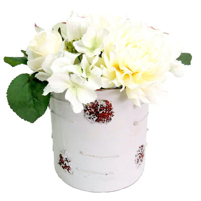 This classic white flower arrangement is perfect for sprucing up any décor. It's designed with an elegant combination of white flowers, with a red detail to add a subtle pop of color. The 18cmH x 18cmD size ensures it takes up minimal space while creating a maximum impact. Bring a graceful touch to any room with this stunning white flower arrangement.
